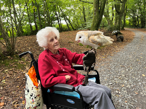 Client in wheelchair holding owl as Carers grant wish